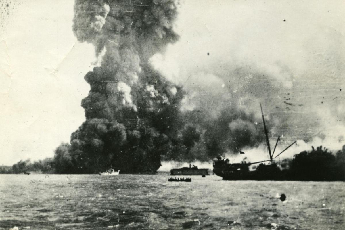 Ship at sea, the 'Neptuna' exploding at Darwin wharf.
