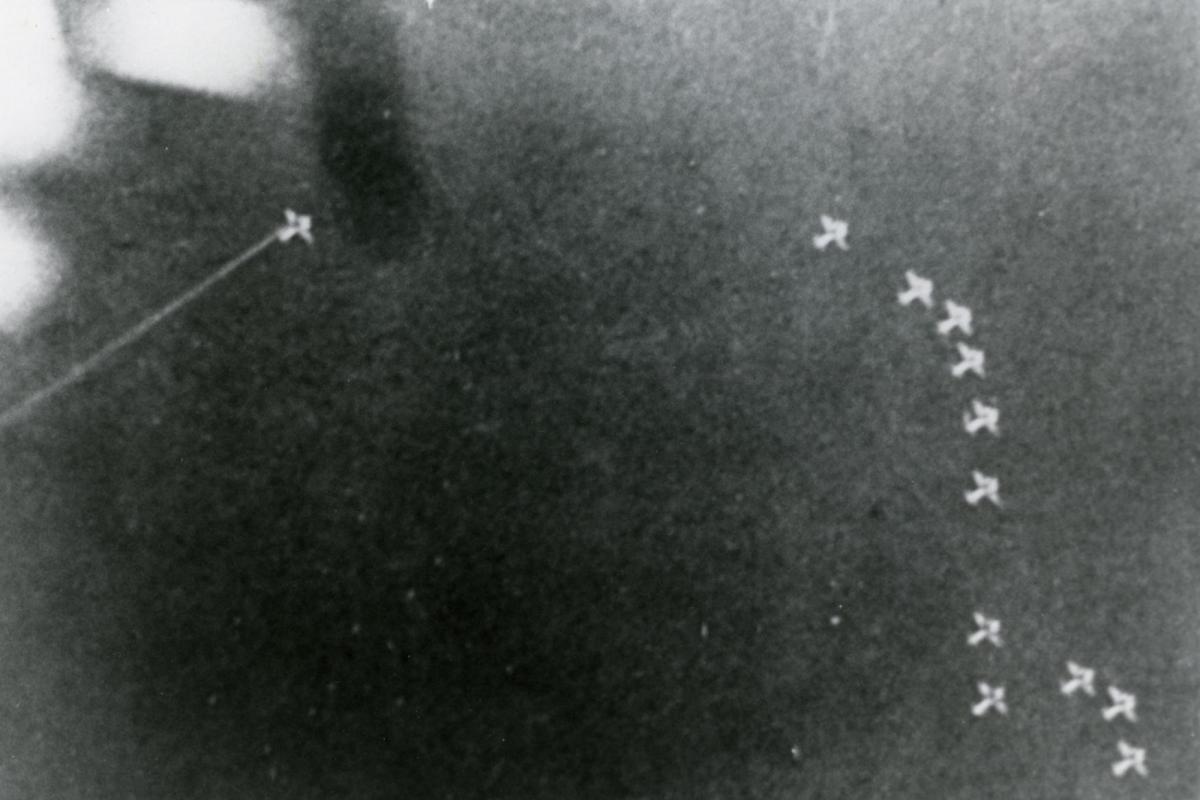 Image from ground looking up at Japanese aeroplanes in formation over Fenton. 