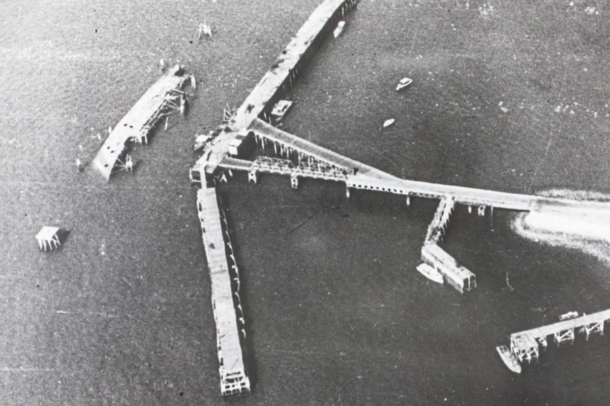 An aerial view of the MV Neptuna lying on its side near Stokes Hill Wharf in Darwin.