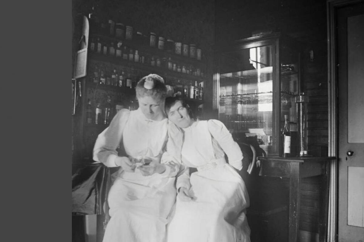 Two sisters are seated at rest in an examination room.