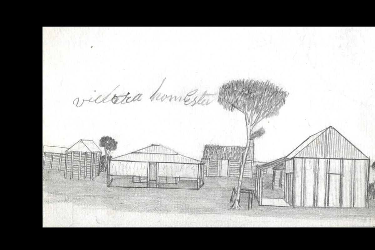 Various station buildings with a tree and horse rail.