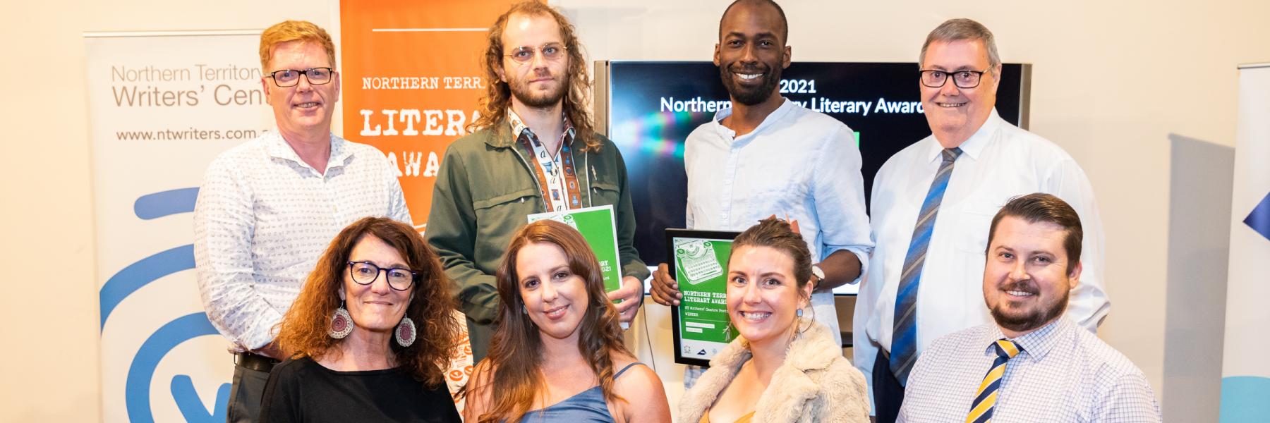 picture of people with certificates and banners