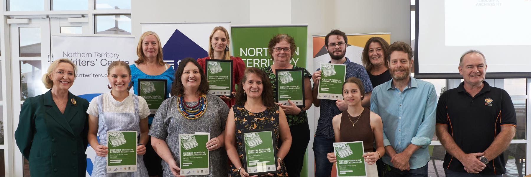 picture of people with certificates and banners