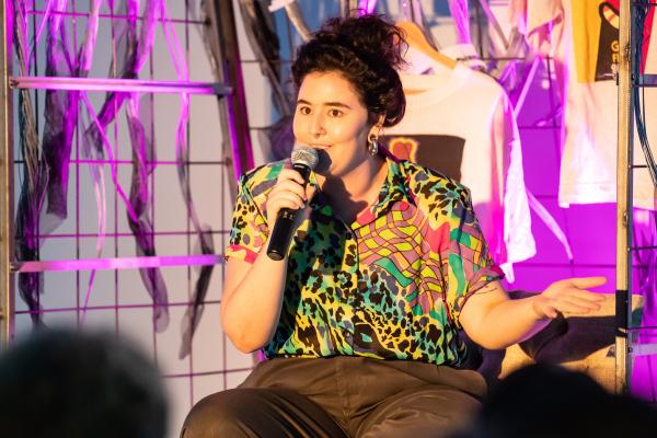 A woman on stage sharing her story