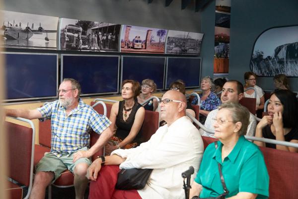 People sitting down and watching the big screen