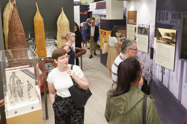 People walking and viewing an exhibition