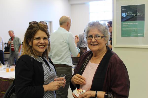 Two women standing and smiling at the camera