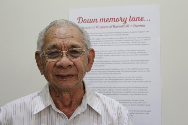 Older gentleman standing in front of exhibition sign