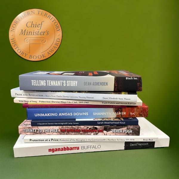 Stack of books on a green background.