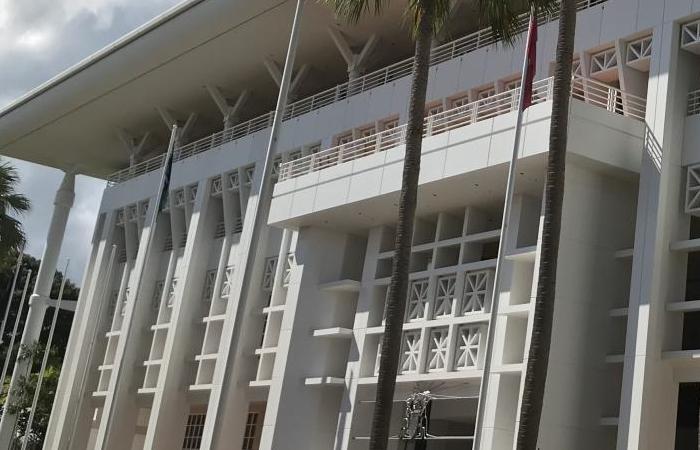 External photo of a large white building with geometric 