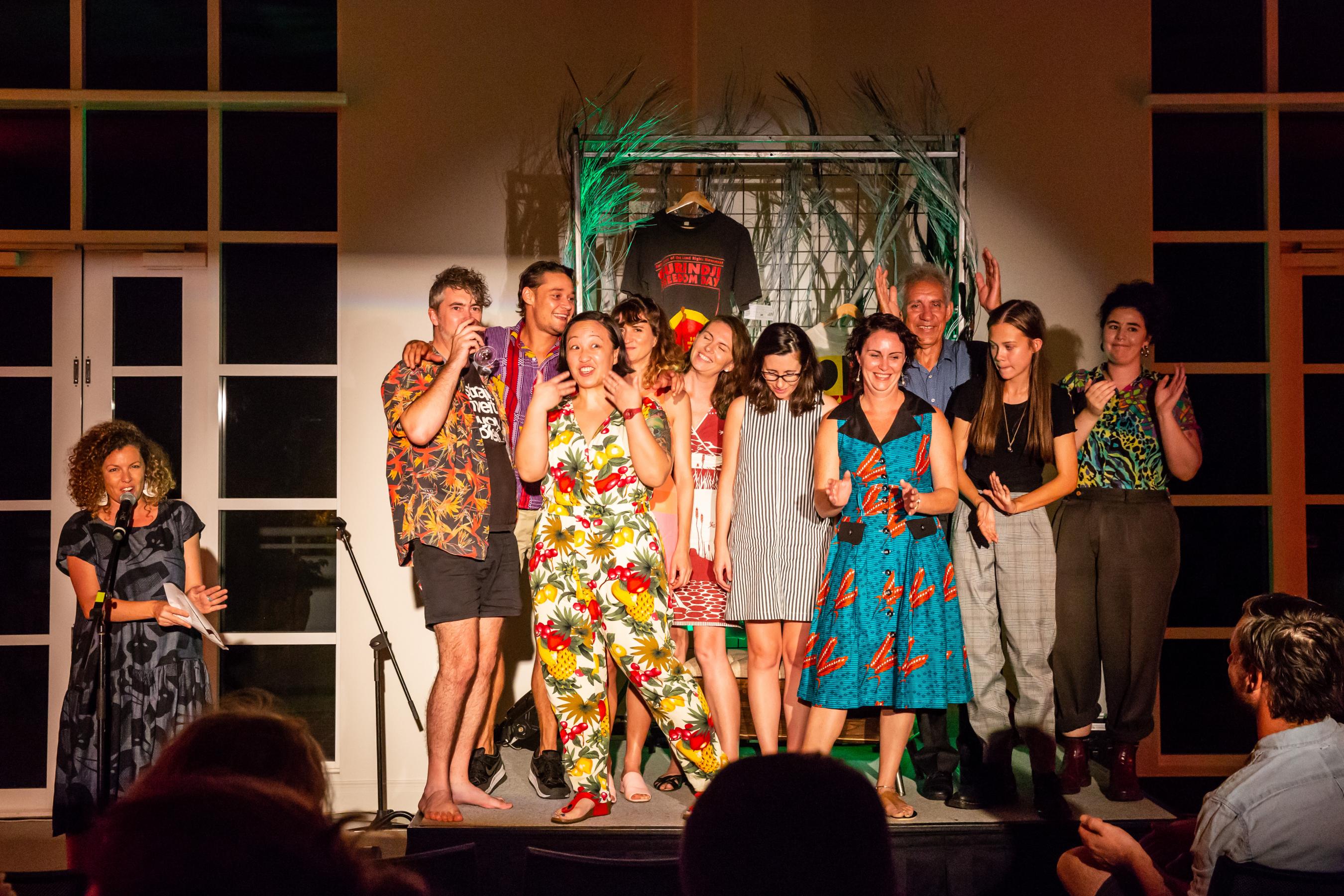 Producers, speakers and organisers of the event stand on stage