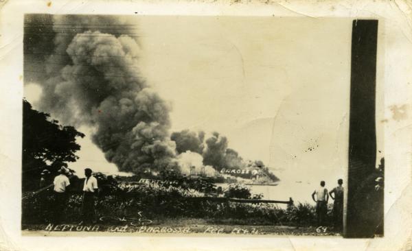 Onlookers observe burning ships in Darwin Harbour after the first Japanese bombing raid in February 1942.