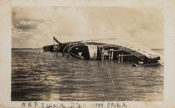 The MV Neptuna lies on its side near Stokes Hill Wharf in Darwin.