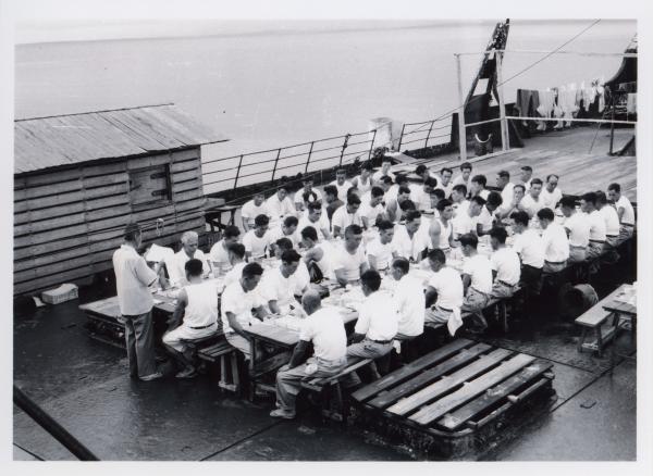 Employees of the Fujita Salvage Company celebrate a New Year’s Day lunch on board the MV British Motorist in 1961.