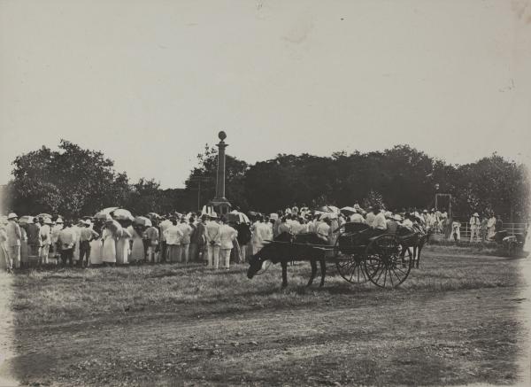 W.J. Barnes (photographer). Library & Archives NT, Peter Spillett Collection, PH0238/1108 A large crowd of men and women surround the Cenotaph at centre. A horse and buggy stand in the foreground.